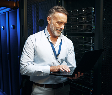 IT professional with laptop in data center